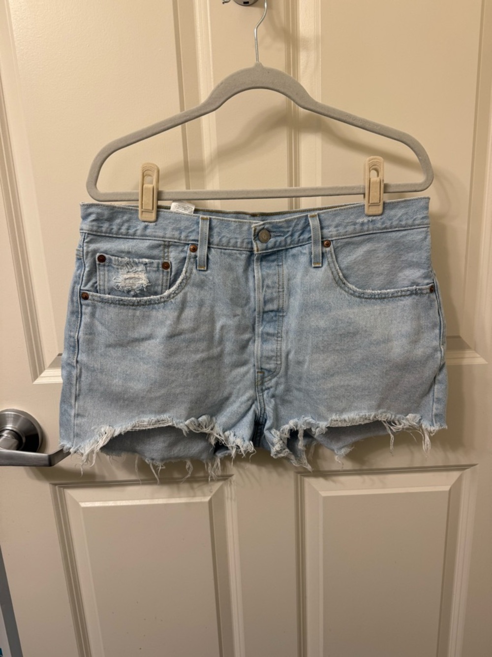 Levi's 501 Light Blue Distressed Denim Cutoff Shorts. Button closure